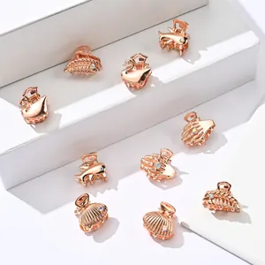 Rose gold metal hair claw set featuring swan and shell shapes with rhinestone accents