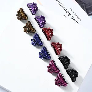 Set of mini floral hair claws in six pearlescent colors including purple and bronze