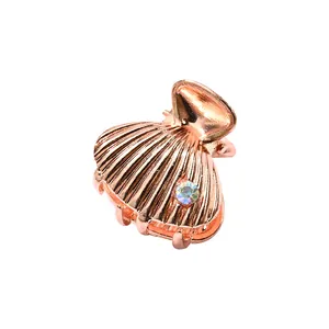 Mini shell shaped metal hair claw in rose gold finish with a sparkling crystal detail