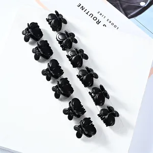 Set of 12 mini black butterfly hair claws made of glossy ABS plastic on display cards