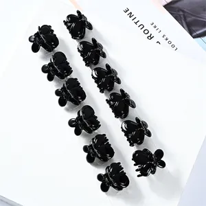Set of 12 mini black butterfly hair claws for women displayed on clear packaging