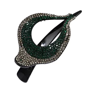 Elegante pinza para el cabello en forma de hoja con pedrería verde y color champán