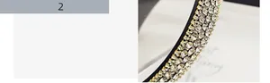 Close-up of sparkling full rhinestone headband with gold metal claw settings on black base