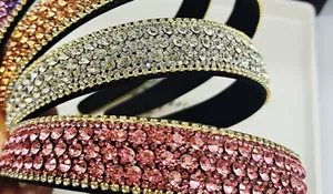 Detailed macro view of wide rhinestone headbands in multiple shimmering color options