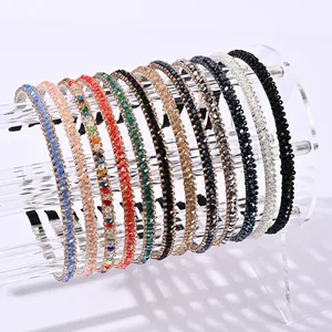 Elegant crystal beaded thin headbands set in various colors on acrylic display stands
