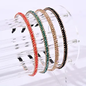 Elegant crystal beaded headbands in red green champagne and black on clear stand