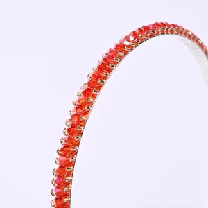 Close-up of orange crystal beaded headband with silver metallic base detail