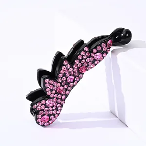Close-up of black banana clip with pink rhinestones for elegant ponytail hairstyles