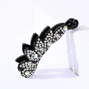 Detail of black banana hair clip featuring sparkling rhinestones and colorful aurora stones