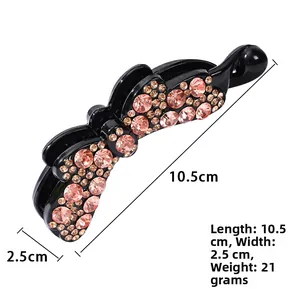 Dettaglio del fermaglio a banana con strass luccicanti e indicazione misura 10,5 cm
