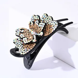 Detail of double-layer butterfly hair claw with colorful rhinestones on black base