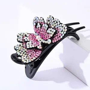 Detail of double-layer butterfly hair claw clip with colorful rhinestones and 3-prong grip