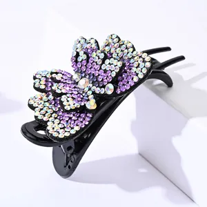Elegant double-layered butterfly hair claw with purple rhinestones on a white stand