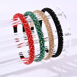 Detailed view of four colorful crystal beaded headbands in red green and black