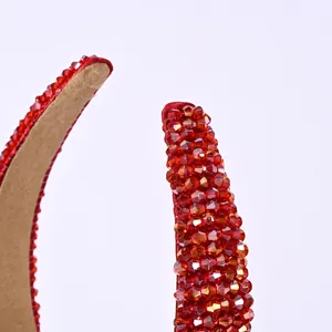 Détail du serre-tête en cristal rouge avec strass et doublure antidérapante