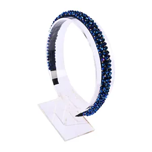 Elegant navy blue crystal beaded headband with sparkling faceted gems on a display stand