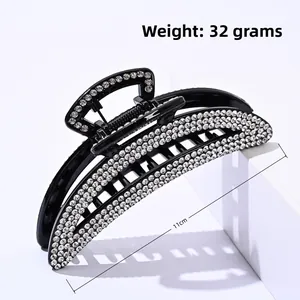 Detail of elegant black hair claw clip with rhinestones showing 11cm length and 32g weight