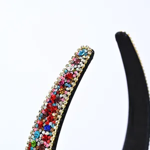 Détails macro de strass colorés sur un serre-tête large noir avec griffes en métal