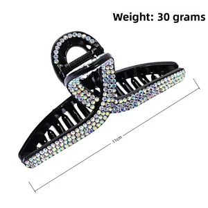 Detail view of 11cm large shark hair claw clip with colorful rhinestones and spring