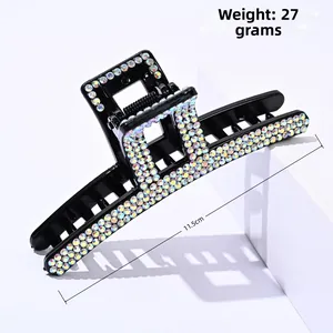 Macro shot of 11.5cm black shark hair claw clip with colorful rhinestones and metal spring