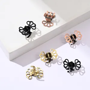 Detailed close-up of six retro metal butterfly hair clips in varied antique finishes
