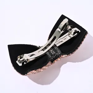Back view of handmade velvet bow barrette with purple crystals and silver clip