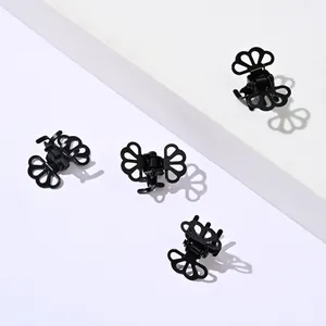 Set of four small vintage hollow butterfly hair claws in glossy black finish