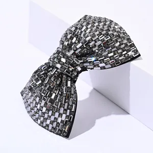 Close-up of sparkling gray rectangular crystals pavé-set on a luxury bow hair clip