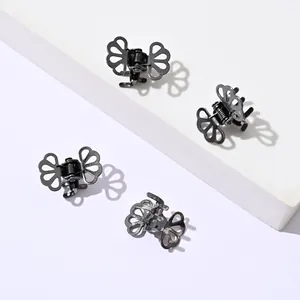 Set of four mini black metal butterfly hair claws with intricate hollow-out pattern details