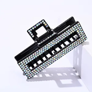 Detailed view of rectangular hair claw clip with colorful AB rhinestones on black base