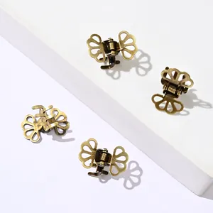 Set of 4 vintage butterfly mini hair claws with hollow metal texture on white blocks