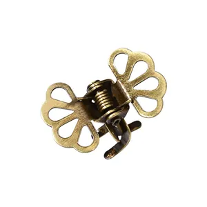 Retro hollow metal hair claw clip in bronze finish with minimalist floral design