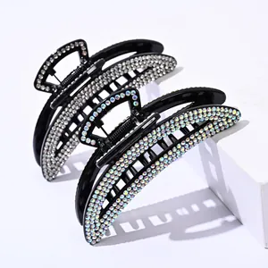 Detail of two large butterfly hair claws featuring sparkling clear and colorful rhinestones