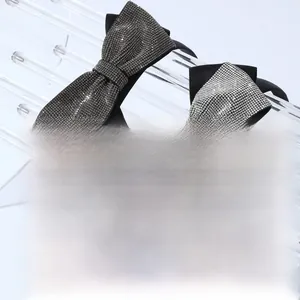 Detail of elegant bow headbands featuring rows of sparkling rhinestones in black and silver