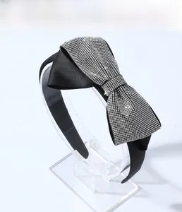 Detail of elegant black bow headband featuring high-density sparkling silver rhinestones