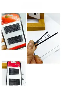 Close-up of black metal wavy hair pins on card set for secure hairstyle hold