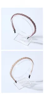 Detail view of woven braided headbands in dusty pink and champagne gold on clear stand