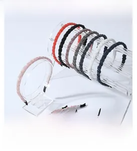 Close-up of colorful braided headbands showing fine weave texture and elastic structure