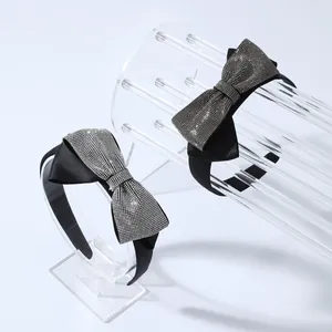 Sparkling rhinestone bow headbands in black satin finish for elegant hair styling