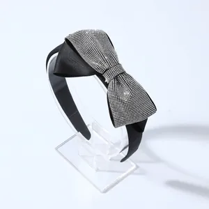 Elegant black satin headband with a sparkling oversized rhinestone bow for women