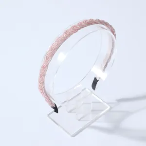 Elegant pink beaded braided headband for women on a transparent acrylic stand