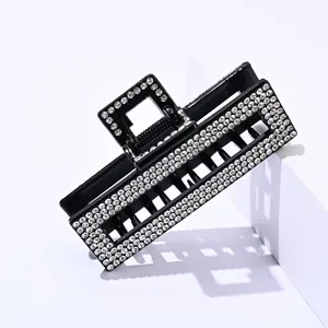 Square black hair claw clip with multiple rows of sparkling rhinestones and metal spring