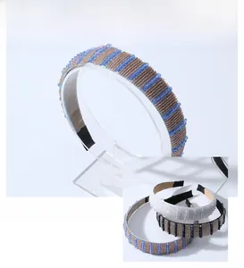 Detail of beaded crystal headband with blue, gold, and white pearls and non-slip inner lining