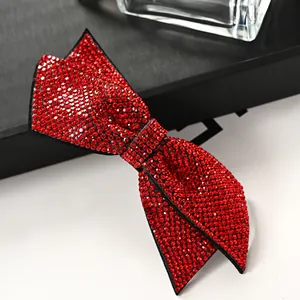 Elegant red sparkling rhinestone bow hair clip shown from a 45-degree angle view