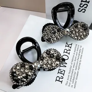 Pinces à cheveux noires élégantes avec design de nœud et strass scintillants