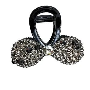Pince à cheveux nœud noir élégante avec strass gris et cristal central pour femme