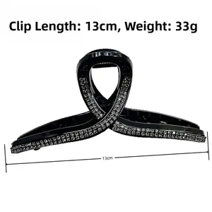 Detail of 13cm large black claw clip with sparkling silver rhinestones for elegant styling