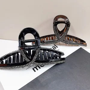 Elegant large hair claw clips set with rhinestones in black and amber colors