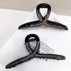 Detail of large rhinestone hair claws in black and coffee brown colors set of two