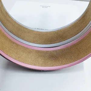Macro detail of premium pink and khaki suede steering wheel cover with non-slip texture